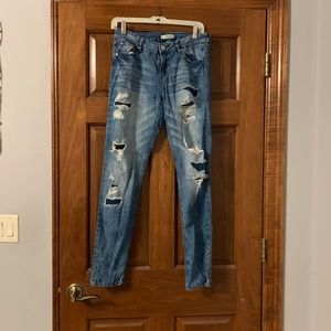Distressed straight legged blue jeans